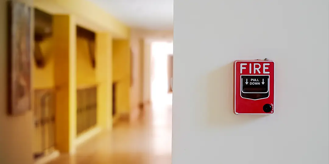 A fire alarm in a hallway at a public location